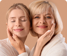 Two smiling women with radiant skin promoting Olay’s Refer a Friend program for Club Olay members